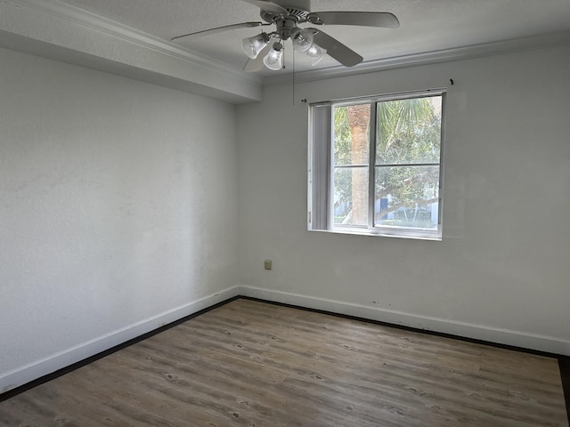 unfurnished room with ceiling fan, ornamental molding, wood-type flooring, and a textured ceiling