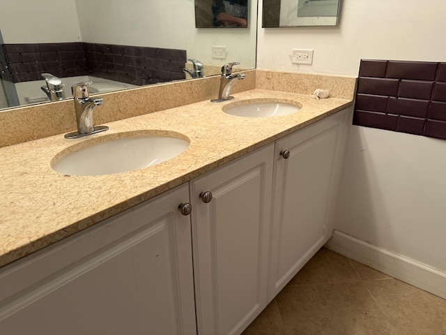 bathroom featuring tile patterned flooring and vanity