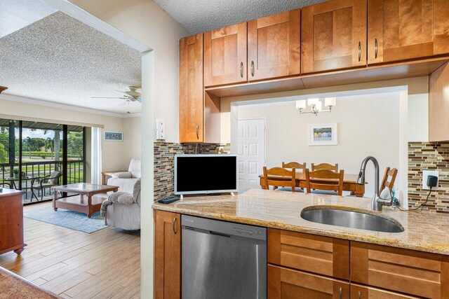 kitchen with dishwasher, a textured ceiling, tasteful backsplash, and hardwood / wood-style flooring