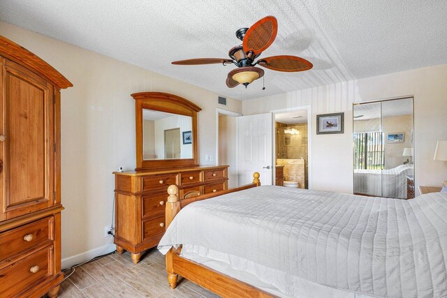 bedroom with a textured ceiling, connected bathroom, a closet, and ceiling fan