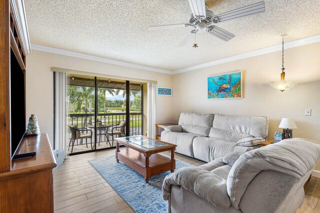 living room with light hardwood / wood-style floors, ornamental molding, a textured ceiling, and ceiling fan