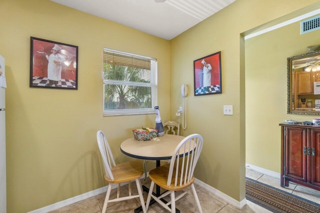 tiled dining room with ceiling fan