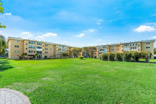 view of home's community with a yard