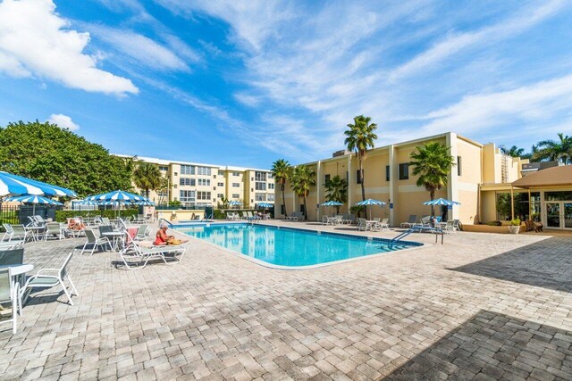 pool featuring a patio area and fence