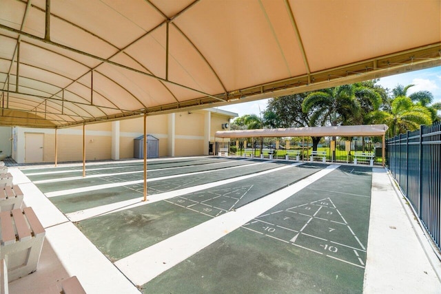 view of home's community featuring shuffleboard and fence