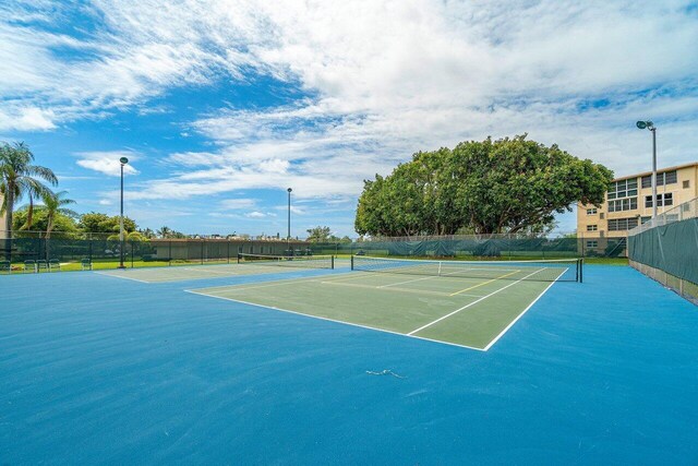view of tennis court with fence