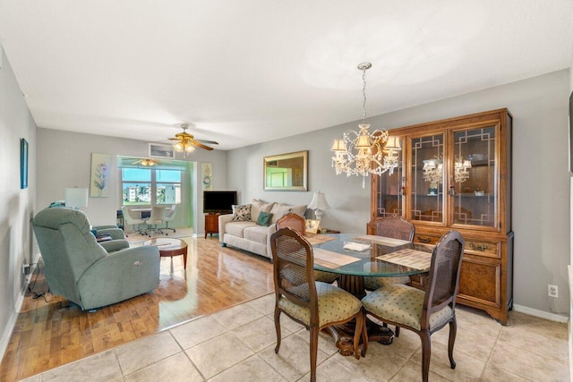 dining area with light tile patterned floors, baseboards, and ceiling fan with notable chandelier