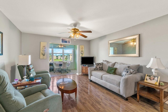 living area featuring ceiling fan and wood finished floors