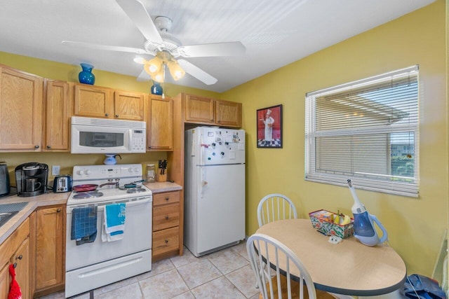 kitchen featuring white appliances, light tile patterned floors, light countertops, and a ceiling fan