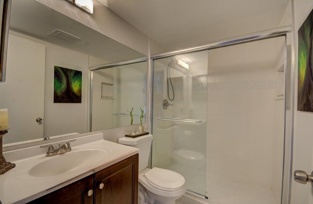 bathroom featuring toilet, vanity, and walk in shower