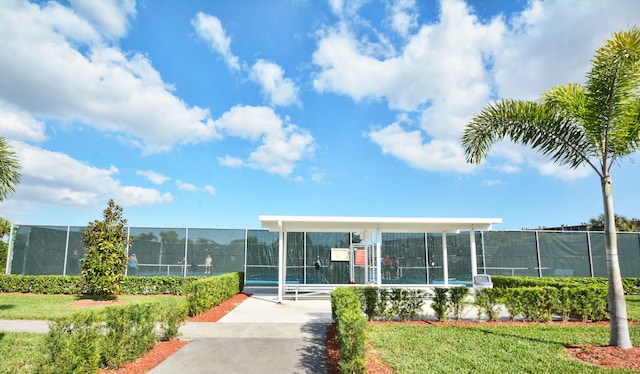 view of home's community with tennis court