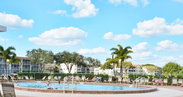 surrounding community featuring a pool and fence