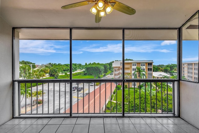 unfurnished sunroom featuring ceiling fan