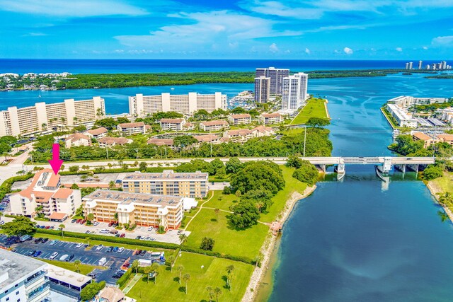 birds eye view of property featuring a water view and a city view