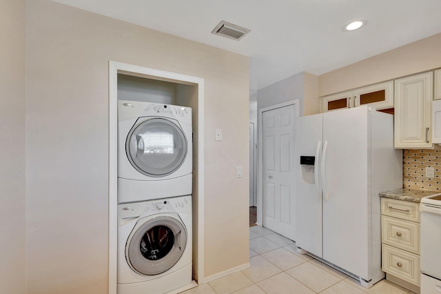 washroom with light tile patterned flooring, recessed lighting, laundry area, visible vents, and stacked washer and clothes dryer