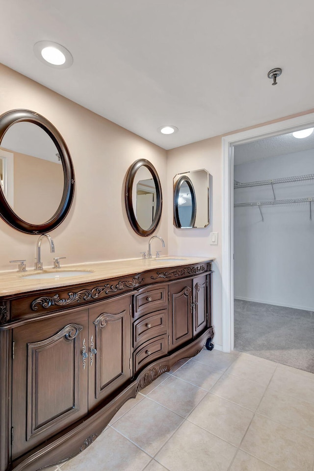 bathroom with tile patterned flooring and dual vanity