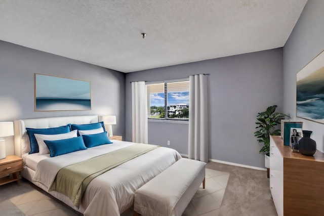 bedroom featuring a textured ceiling and light colored carpet