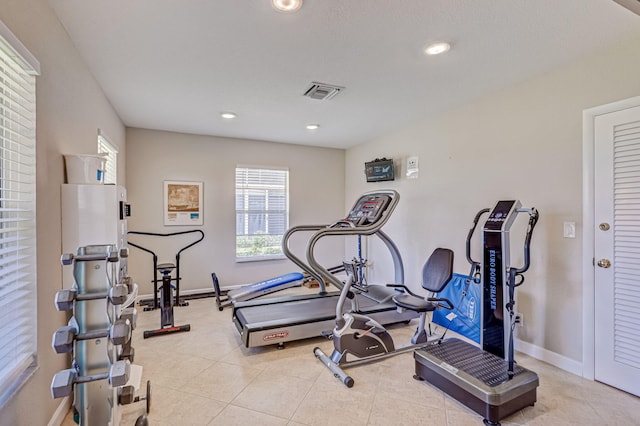 workout area featuring light tile patterned floors