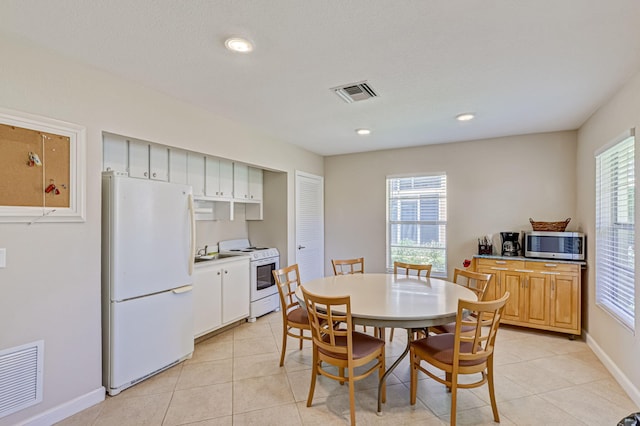 dining area featuring a healthy amount of sunlight and light tile patterned floors