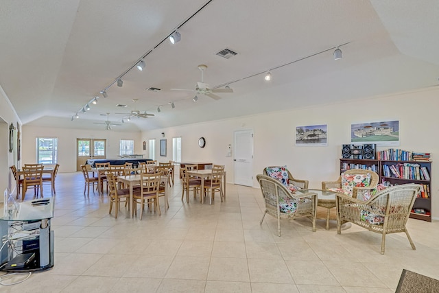 tiled dining space featuring ceiling fan and track lighting