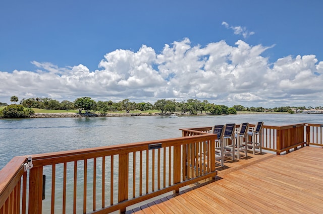 view of dock with a deck with water view