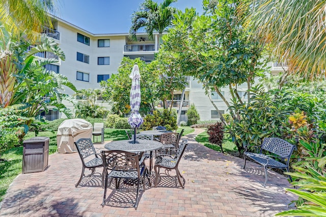 view of patio featuring grilling area and a balcony