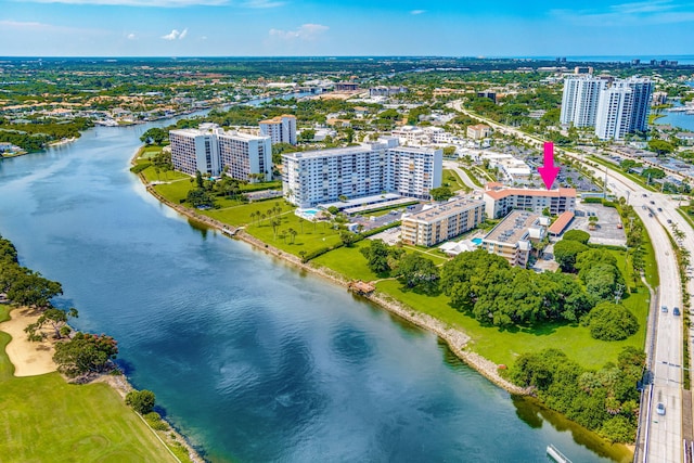 birds eye view of property with a water view and a city view