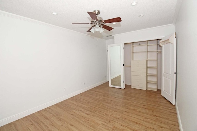 unfurnished bedroom with a closet, ceiling fan, ornamental molding, light hardwood / wood-style floors, and a textured ceiling