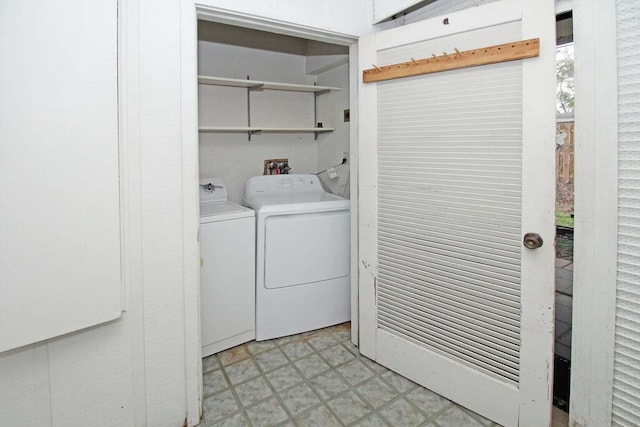 laundry room with washer and clothes dryer and light tile patterned floors