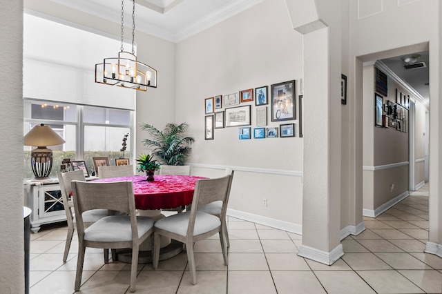 tiled dining area with a notable chandelier, crown molding, and a towering ceiling