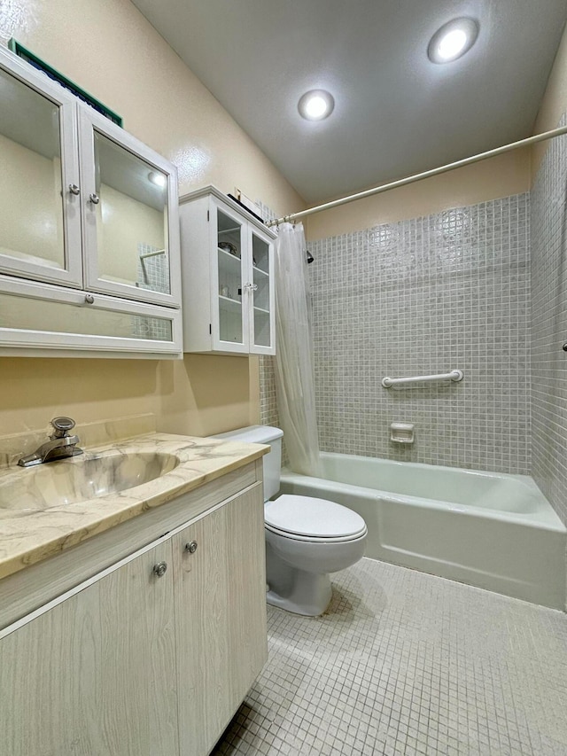 full bathroom with tile patterned floors, shower / bath combination with curtain, toilet, and vanity