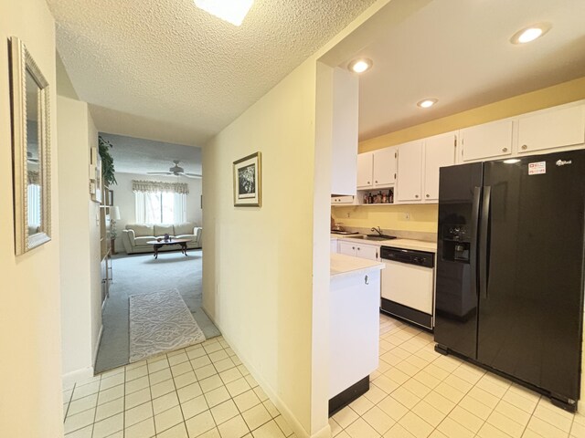 kitchen with white cabinets, light colored carpet, dishwasher, ceiling fan, and black refrigerator with ice dispenser