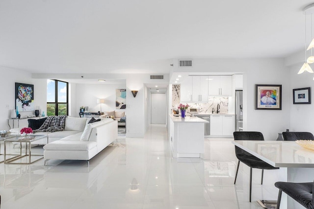 tiled living room featuring sink