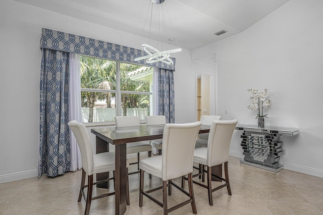 dining space featuring a chandelier