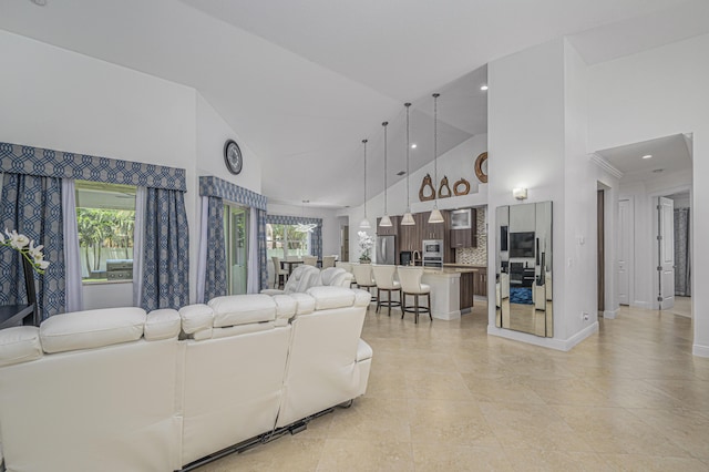 living room with high vaulted ceiling