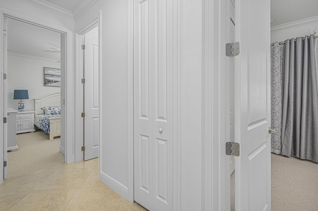 hall featuring crown molding and light colored carpet