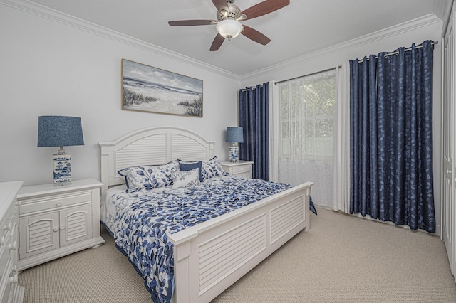 carpeted bedroom with ceiling fan and crown molding