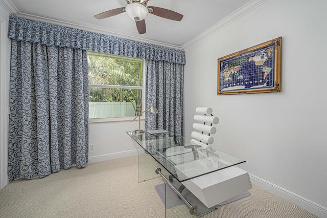 carpeted home office featuring ceiling fan and crown molding