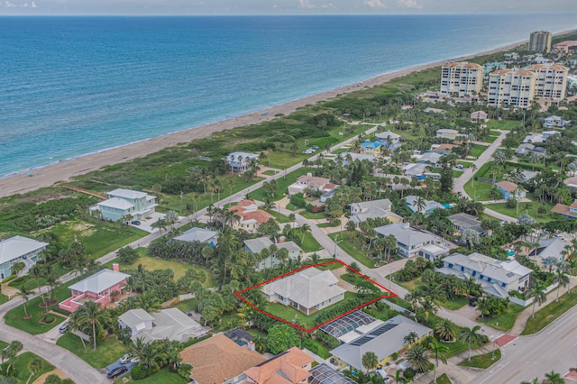 bird's eye view featuring a view of the beach and a water view