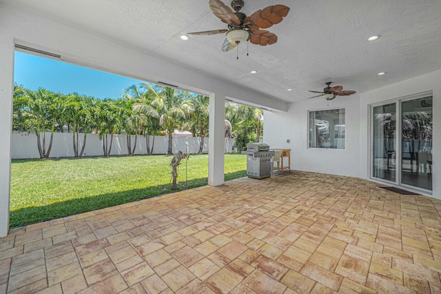 unfurnished sunroom with ceiling fan