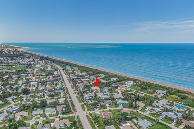 drone / aerial view with a beach view and a water view