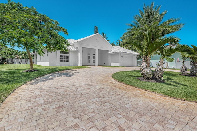 view of front facade with a front yard and a garage