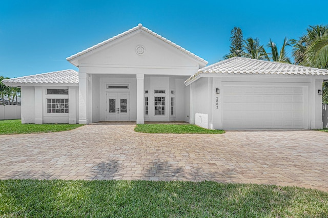 view of front of property with french doors and a garage