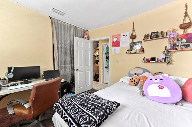 bedroom featuring light tile patterned floors and visible vents