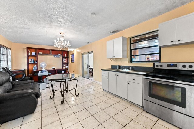 kitchen with a chandelier, visible vents, white cabinetry, electric stove, and dark countertops