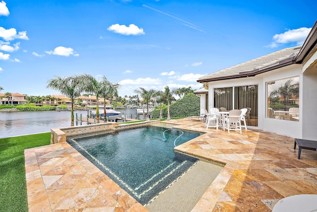 view of swimming pool featuring a water view and a patio area