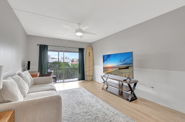 living room with light hardwood / wood-style floors and ceiling fan