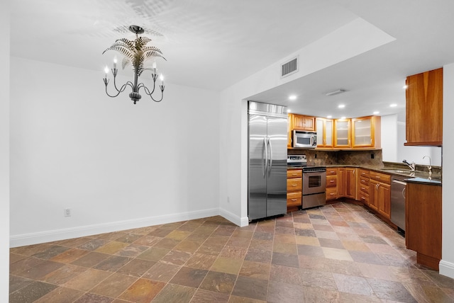 kitchen featuring a chandelier, appliances with stainless steel finishes, tasteful backsplash, and sink