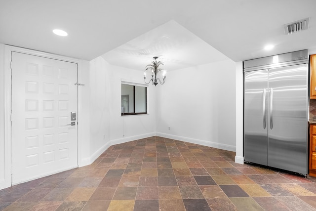 unfurnished dining area featuring an inviting chandelier