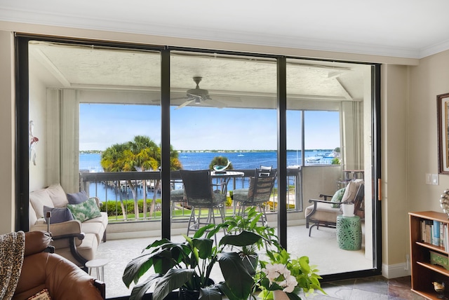 doorway featuring ceiling fan, crown molding, and a water view